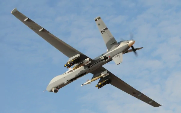 Military General Atomics MQ-9 Reaper drone in flight against a blue sky — 2K Quad HD PC desktop wallpaper background.