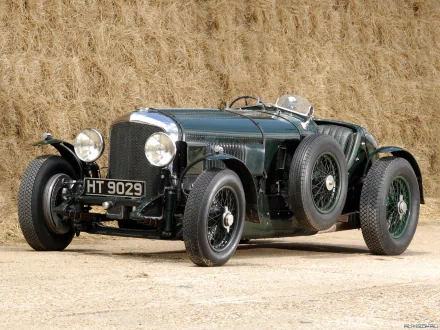Dark green Bentley 3/8 Litre vintage racing car parked before stacked hay bales — HD PC desktop wallpaper and background.