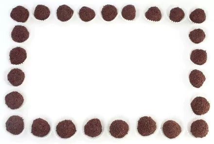 HD PC desktop wallpaper featuring a white background framed by evenly spaced round chocolate truffles, highlighting the rich texture of the food.