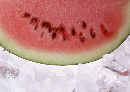 Close-up of a juicy watermelon slice resting on ice, captured in high definition as a vibrant PC desktop wallpaper and background.