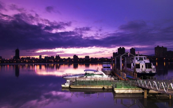Dadaocheng, Taipei, Taiwan — man-made riverside dock with moored boats and city skyline reflected in purple dusk, HD PC desktop wallpaper.