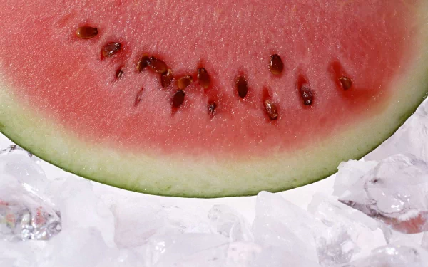 Close-up of a juicy watermelon slice resting on ice, captured in high definition as a vibrant PC desktop wallpaper and background.
