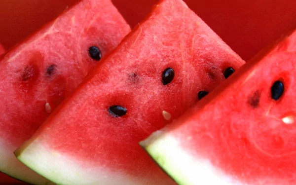 Close-up of juicy watermelon slices with seeds, displayed as a vibrant HD PC desktop wallpaper and background.