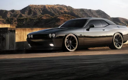 A sleek Dodge Charger parked against a scenic backdrop, showcasing its striking design. This HD PC desktop wallpaper captures the vehicle's bold presence and dynamic style.