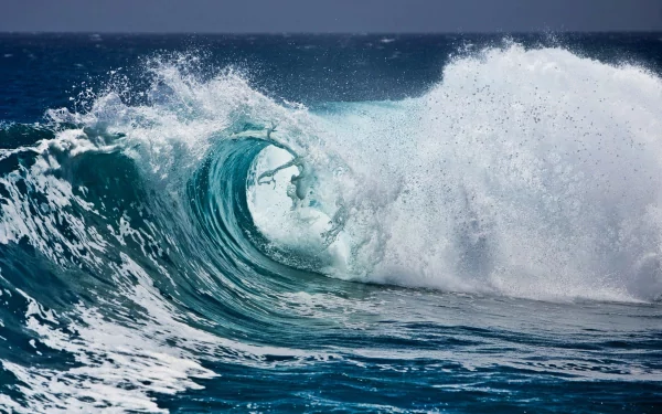 HD PC desktop wallpaper featuring a dynamic ocean wave crashing, capturing the raw beauty of nature in vibrant detail.