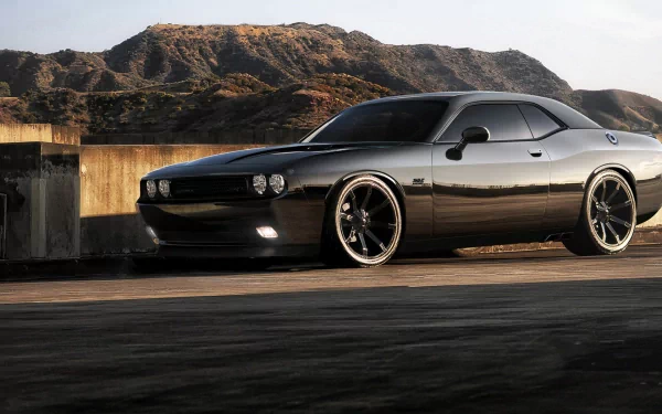 A sleek Dodge Charger parked against a scenic backdrop, showcasing its striking design. This HD PC desktop wallpaper captures the vehicle's bold presence and dynamic style.