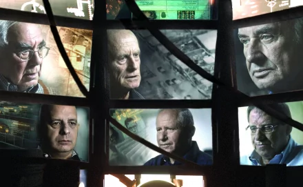 HD desktop wallpaper featuring a collage of serious-faced individuals, tagged The Gatekeepers, set against a backdrop of surveillance screens.