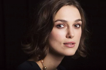 HD PC desktop wallpaper featuring a close-up portrait of celebrity Keira Knightley against a dark background.
