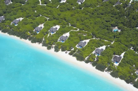 Aerial photography of a lush green coastline with white sandy beach and turquoise water, featured as an HD PC desktop wallpaper and background.