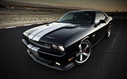 A sleek black Dodge Challenger SRT8 392 with white racing stripes, captured on an open road at dusk, featured as an HD PC desktop wallpaper.