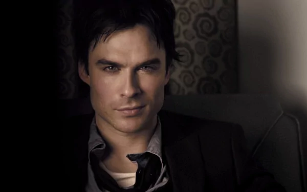 HD desktop wallpaper featuring Ian Somerhalder, exuding a confident and intense gaze while dressed in a dark suit, with a patterned background.