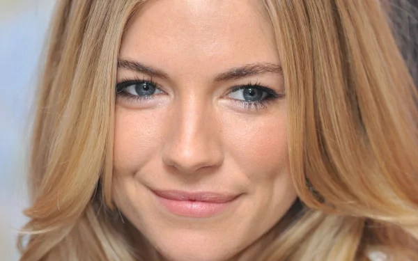HD PC desktop wallpaper featuring a close-up portrait of celebrity Sienna Miller with blonde hair and a subtle smile.
