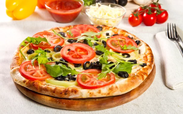A vibrant 4K Ultra HD PC desktop wallpaper featuring a fresh vegetable pizza topped with tomatoes, olives, and greens, set against a bright background with ingredients.