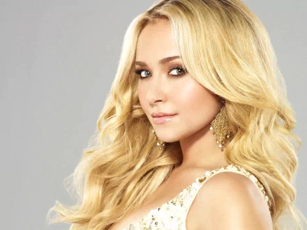 HD desktop wallpaper featuring a close-up portrait of celebrity Hayden Panettiere with long blonde hair and gold earrings against a light gray background.