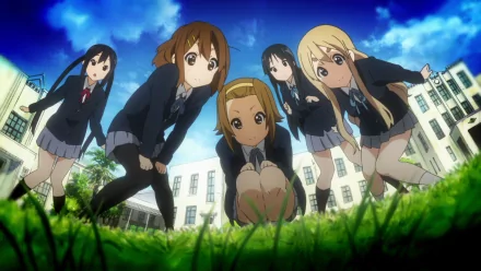 HD PC desktop wallpaper featuring the main female characters from the anime K-ON! posed outdoors with a vibrant blue sky and school building in the background.