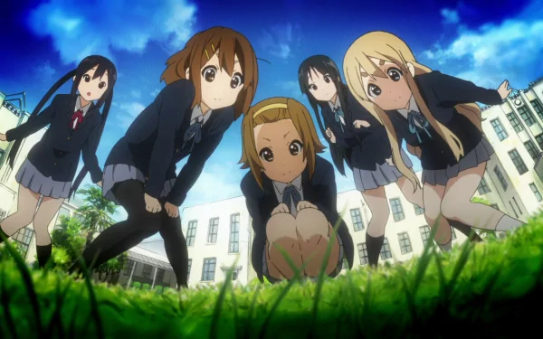 HD PC desktop wallpaper featuring the main female characters from the anime K-ON! posed outdoors with a vibrant blue sky and school building in the background.