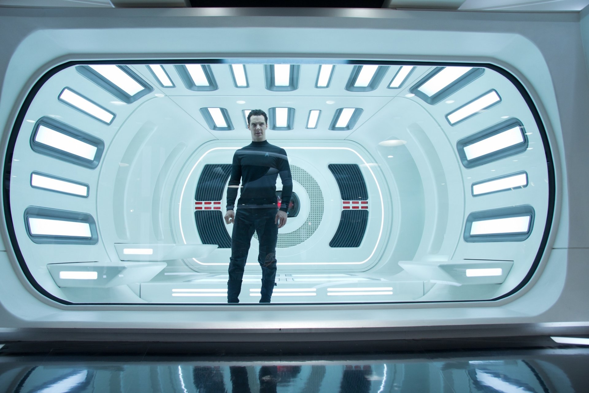 HD PC desktop wallpaper featuring a scene from the movie Star Trek Into Darkness, showing a character standing inside a futuristic, brightly lit corridor.