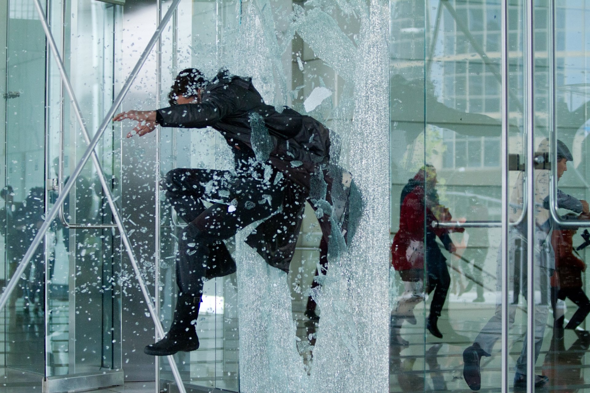HD PC desktop wallpaper from the movie Star Trek Into Darkness, featuring a dynamic action scene with a character crashing through glass in a futuristic setting.