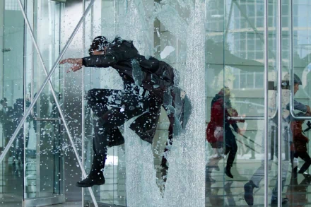 HD PC desktop wallpaper from the movie Star Trek Into Darkness, featuring a dynamic action scene with a character crashing through glass in a futuristic setting.
