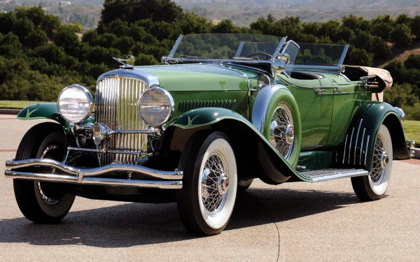 Green Duesenberg Model J Dual Cowl Phaeton vintage vehicle showcased in a high-definition desktop wallpaper background.
