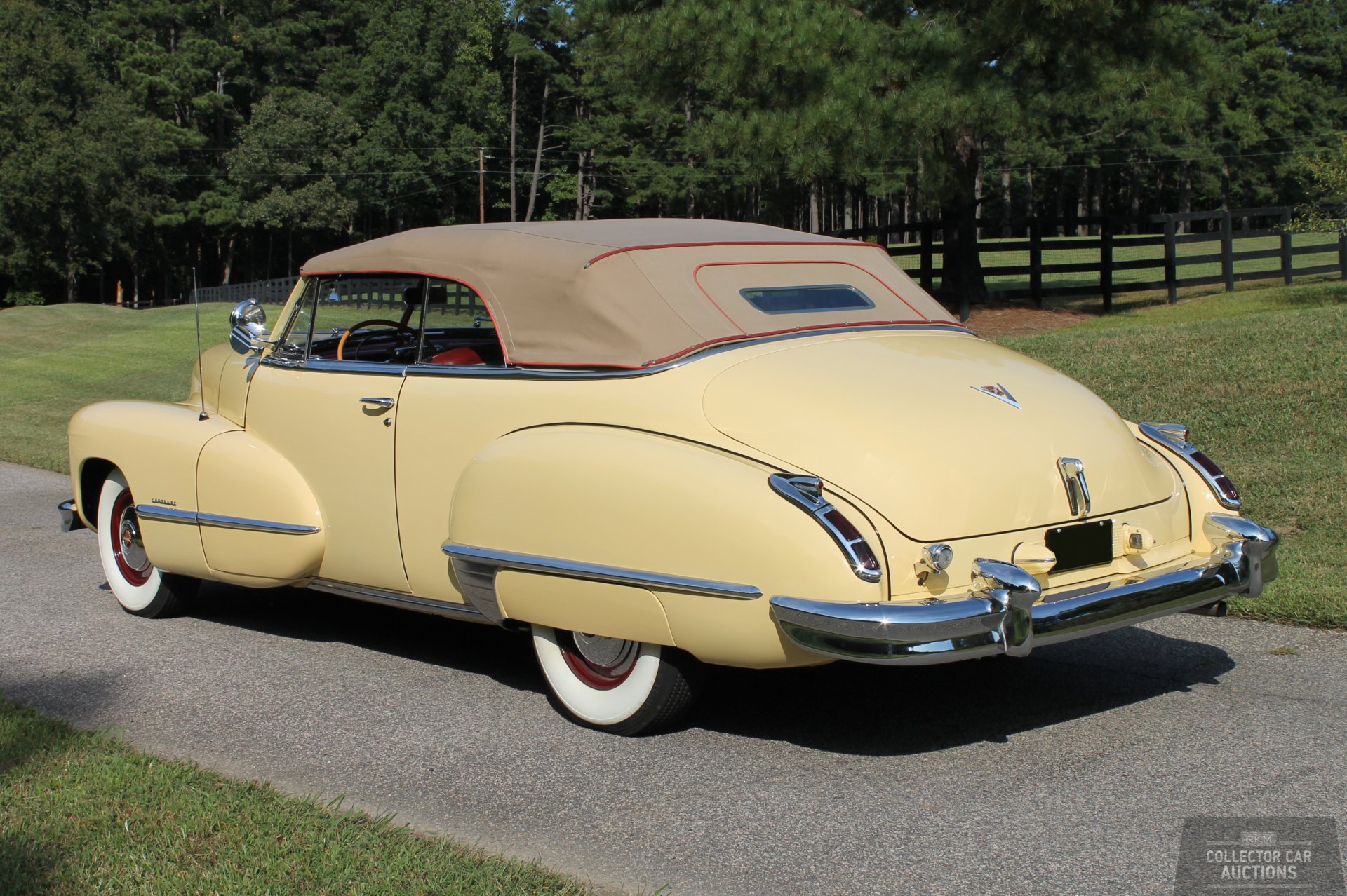 A beige 1946 Cadillac Series 62 convertible parked on a driveway with a forest and wooden fence in the background, captured in HD for PC desktop wallpaper.