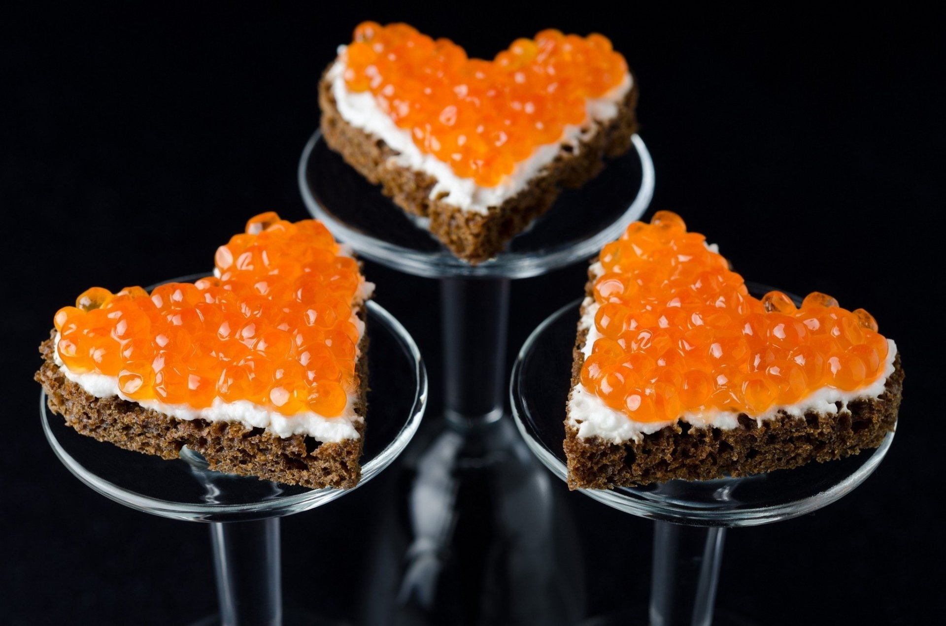 HD desktop wallpaper featuring heart-shaped appetizers topped with vibrant orange caviar on a dark background, highlighting food and caviar themes.