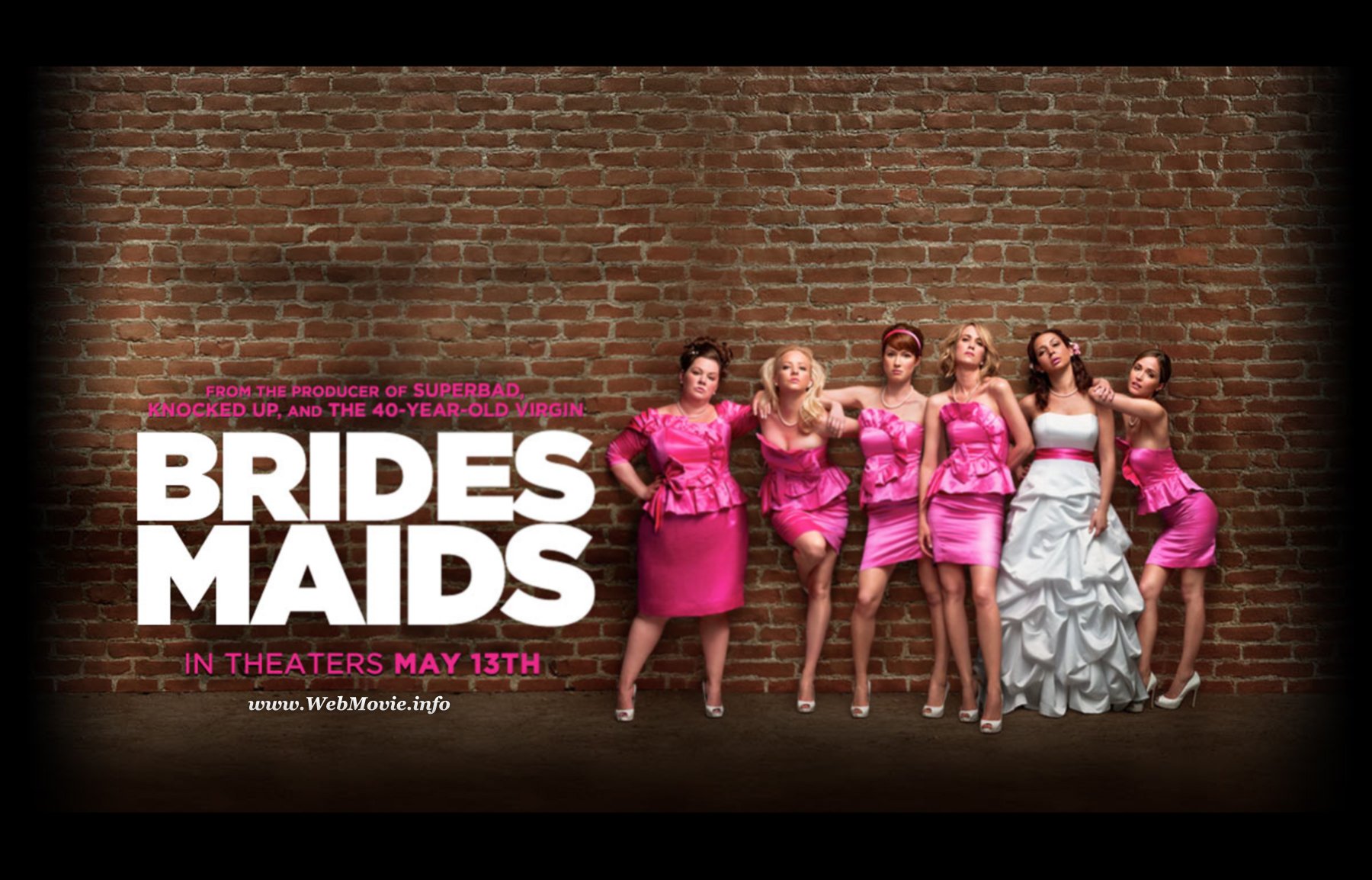 HD desktop wallpaper featuring the cast of the movie Bridesmaids in formal attire against a brick wall background.