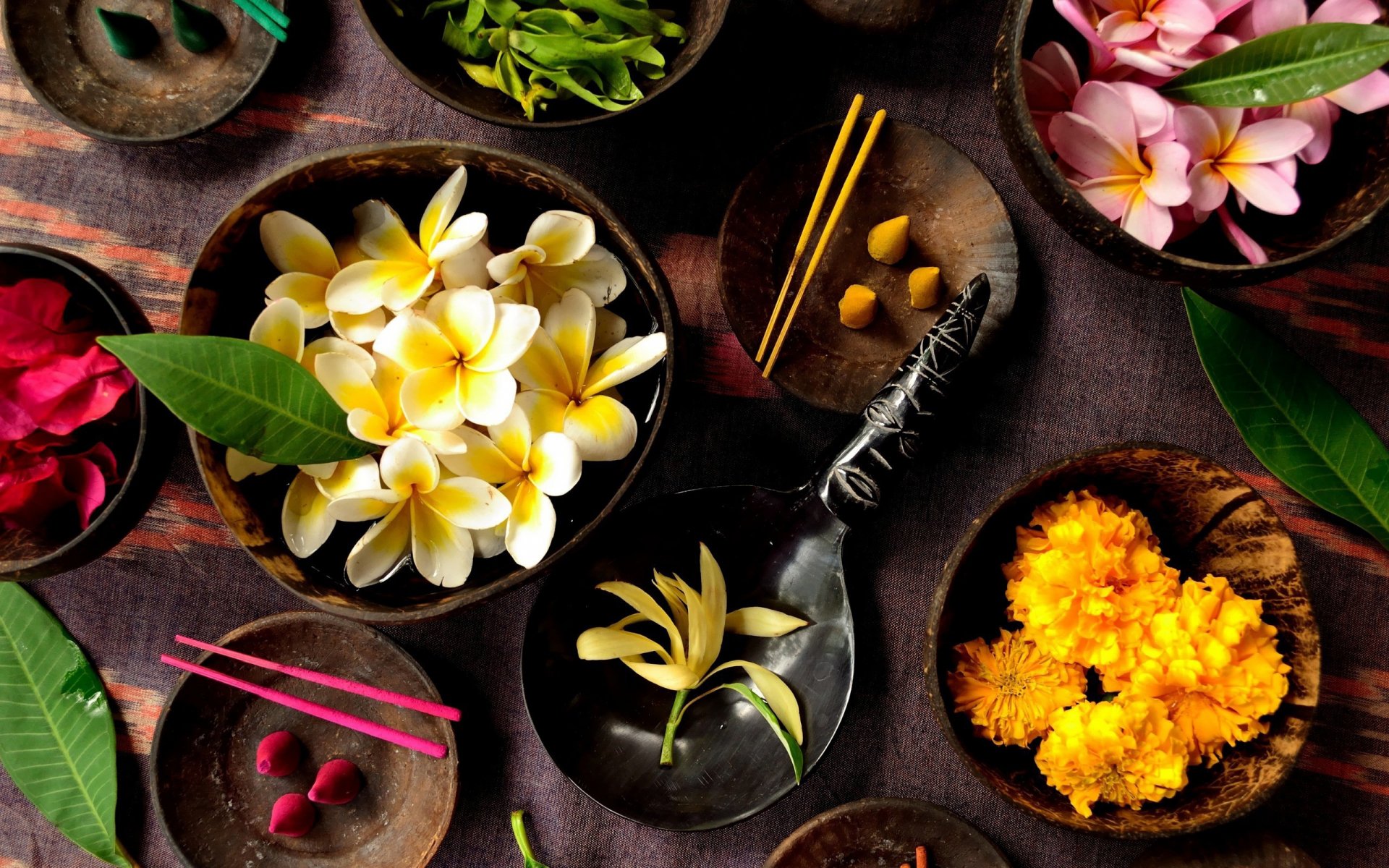 Still life photography of vibrant flowers and incense in wooden bowls, captured as an HD PC desktop wallpaper and background with rich colors and textures.