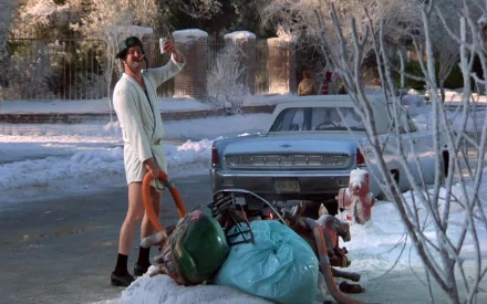 HD PC desktop wallpaper from the movie National Lampoon's Christmas Vacation, featuring a snowy suburban street with a man in a robe and a vintage car.