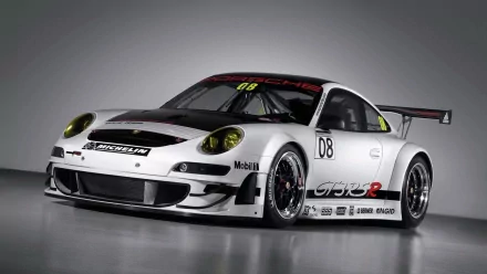 HD desktop wallpaper of a white Porsche 911 GT3 RSR race car showcasing sleek design and racing decals against a neutral background.