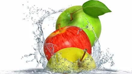 HD PC desktop wallpaper featuring vibrant red, green, and yellow apples splashing in clear water against a white background, highlighting freshness and food.