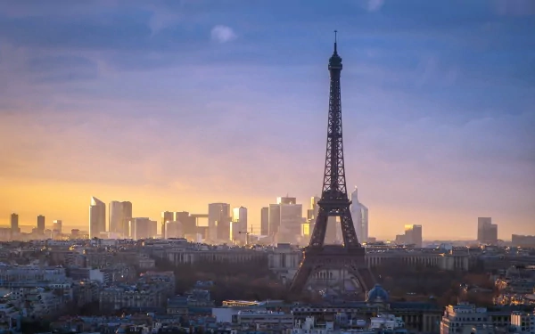 A stunning HD wallpaper showcasing the Eiffel Tower against the Paris skyline at sunset, highlighting the blend of historic architecture and modern cityscape.