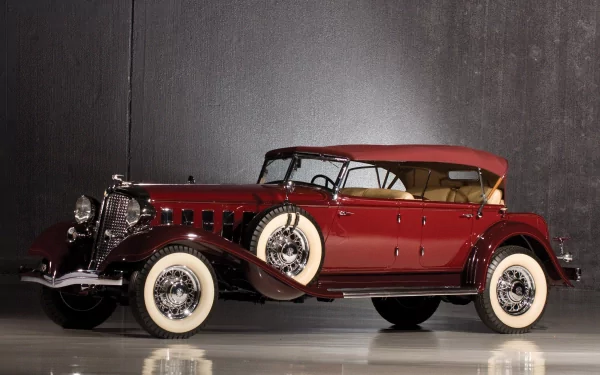 A sleek, vintage 1933 Chrysler Imperial with a deep red body and tan convertible top, showcased as an HD PC desktop wallpaper and background.