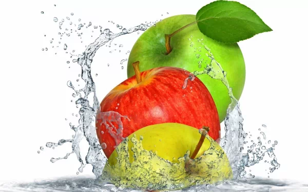 HD PC desktop wallpaper featuring vibrant red, green, and yellow apples splashing in clear water against a white background, highlighting freshness and food.