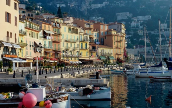 Scenic view of the colorful buildings and boats docked along the waterfront in Villefranche-sur-Mer, France, captured in this HD desktop wallpaper.