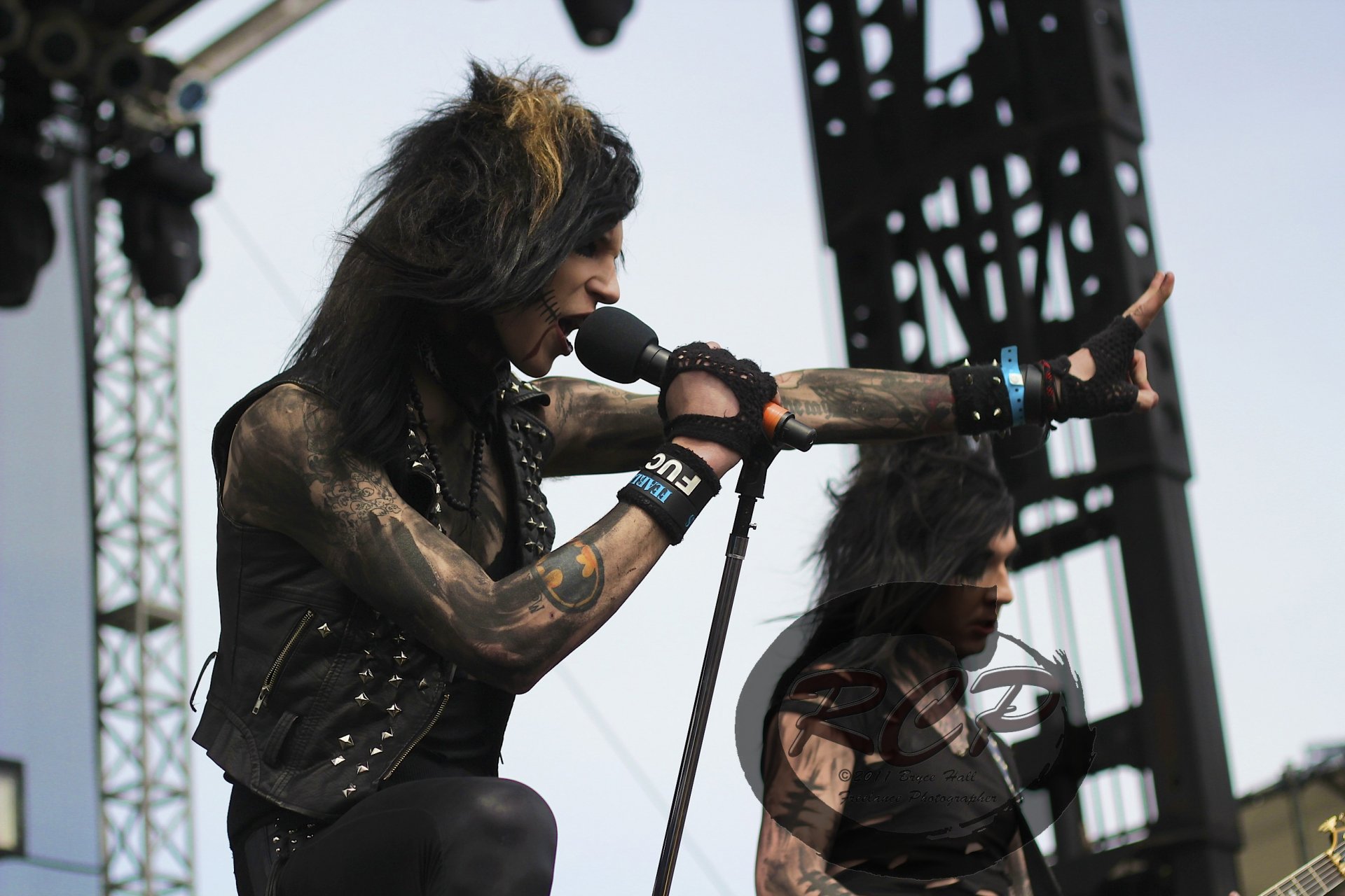 Live performance photo of Black Veil Brides with the lead singer passionately singing into the microphone, captured as an HD PC desktop wallpaper background.