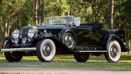 Black vintage Cadillac V16 convertible parked on a tree-lined road; high-resolution 2K Quad HD PC desktop wallpaper/background.