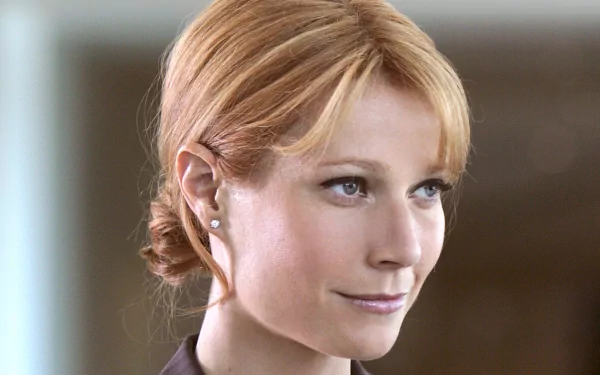 Gwyneth Paltrow in a scene from the movie Iron Man, featuring her elegant hairstyle and confident expression, captured in a high-definition desktop wallpaper.