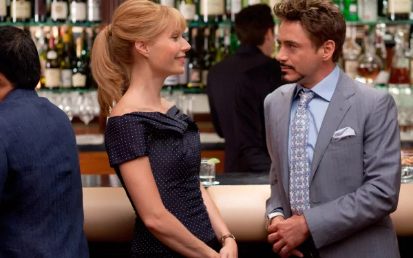 HD desktop wallpaper featuring Iron Man characters Tony Stark and Pepper Potts, portrayed by Robert Downey Jr. and Gwyneth Paltrow, engaging in conversation at a bar.