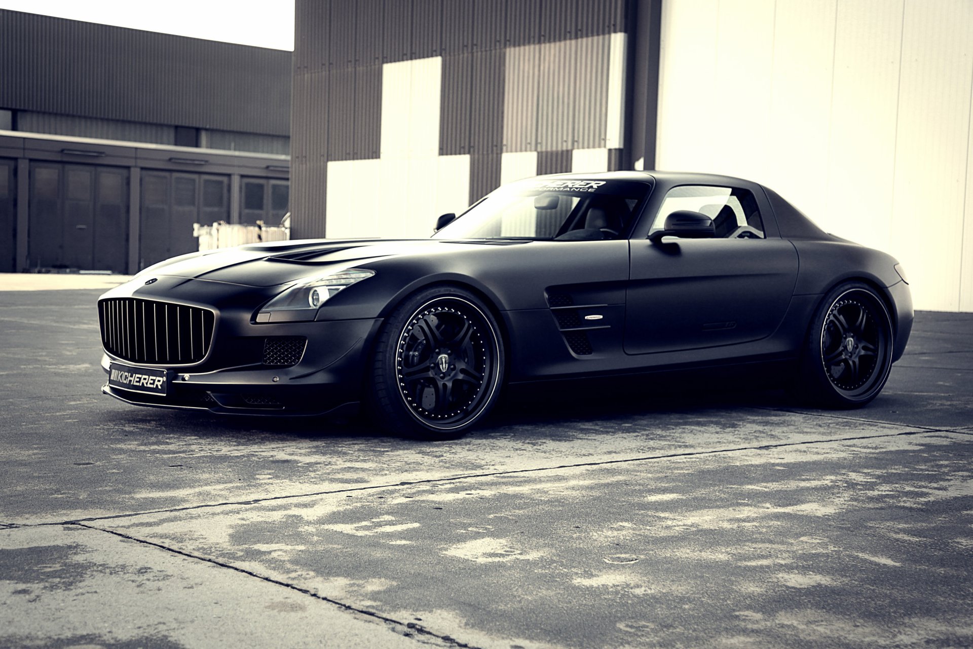 A sleek black Kicherer Mercedes-Benz SLS AMG with gull-wing doors, showcased as a high-definition PC desktop wallpaper and background.