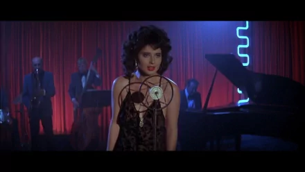HD PC desktop wallpaper featuring a scene from the movie Blue Velvet, with a woman singing in front of a vintage microphone and a band playing in the background.