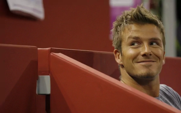 HD PC desktop wallpaper featuring a close-up of David Beckham smiling, set against a sports-related background.