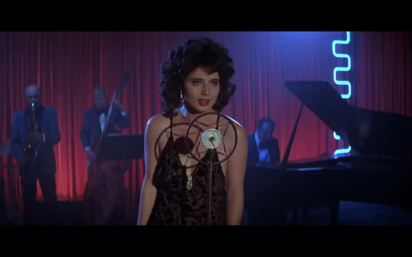 HD PC desktop wallpaper featuring a scene from the movie Blue Velvet, with a woman singing in front of a vintage microphone and a band playing in the background.