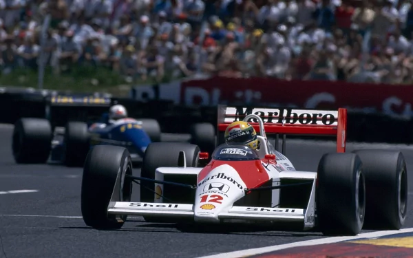 4K Ultra HD PC desktop wallpaper: vintage Marlboro‑liveried F1 car #12 leading a pack on a sunlit racetrack, high-speed motorsport action, sports background