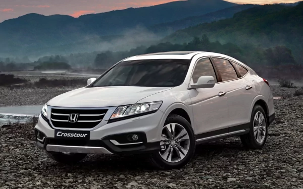 Silver Honda Crosstour vehicle on a rocky shoreline with misty mountains in the background — HD PC desktop wallpaper background.