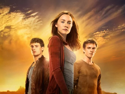 A dramatic scene featuring Max Irons, Jake Abel, and Saoirse Ronan from the movie *The Host* (2013), set against an atmospheric sunset backdrop.