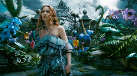 Mia Wasikowska as Alice stands in a vibrant, surreal garden from the movie Alice in Wonderland (2010), surrounded by colorful plants and mystical scenery.