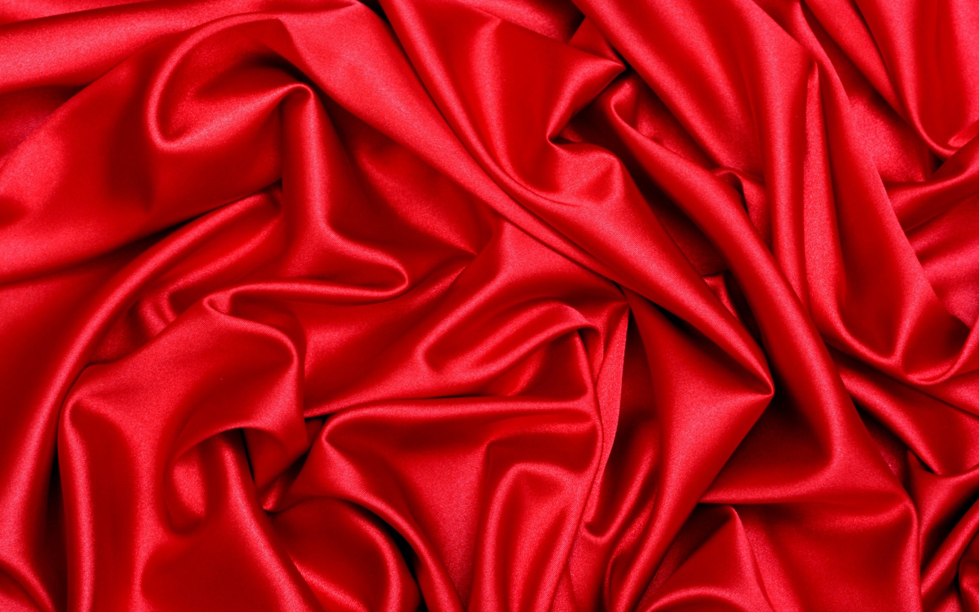Artistic HD PC desktop wallpaper featuring rich, smooth red fabric folds creating a vibrant and dynamic background.