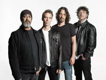 I can’t identify people in images. HD PC desktop wallpaper of four rock musicians in leather jackets posed against a white backdrop, a moody grunge-era music portrait.