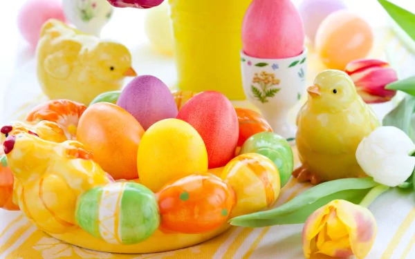 A vibrant Easter-themed desktop wallpaper featuring colorful eggs, cheerful chicks, and tulips, creating a festive and joyful holiday atmosphere.